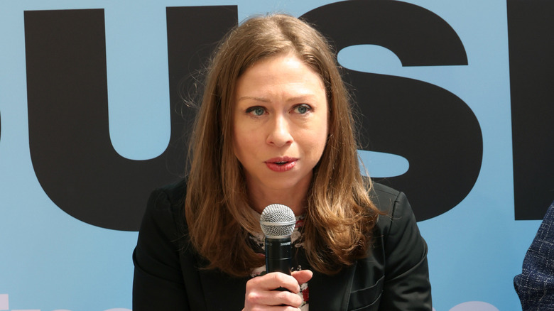 Chelsea Clinton speaking into mic