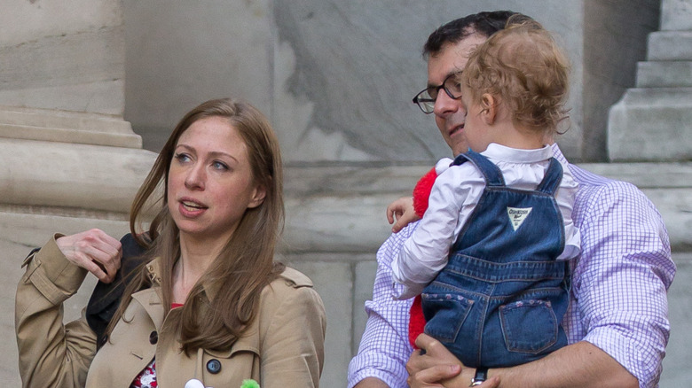Chelsea Clinton and husband Marc Mezvinsky on walk with daughter Charlotte