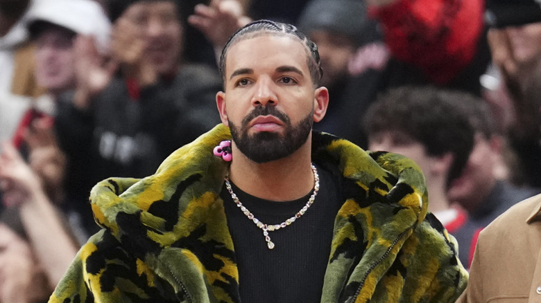 Drake looking sad at a basketball game