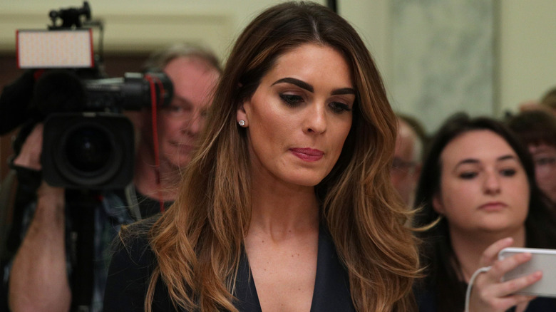 Hope Hicks standing in front of a camera looking down