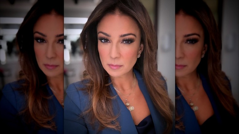 Julie Banderas wearing a blue blazer and stacked necklaces