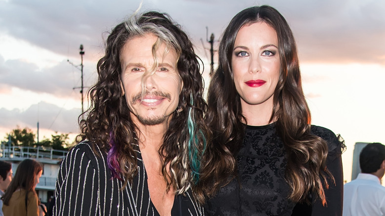Steven Tyler and Liv Tyler smiling at a Givenchy show
