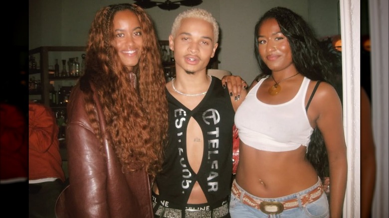 Sasha and Malia posing with musician Destin Conrad in 2025