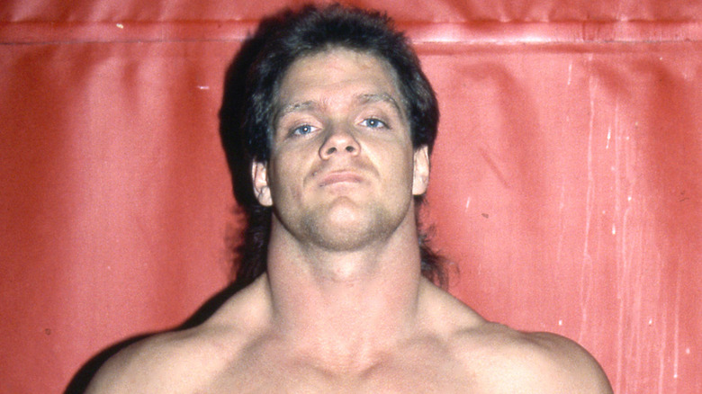 Chris Benoit posing in his wrestling gear in his younger days