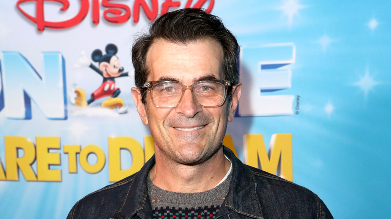 Ty Burrell on red carpet wearing glasses and smiling
