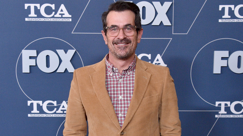 Ty Burrell smiling in suit on red carpet