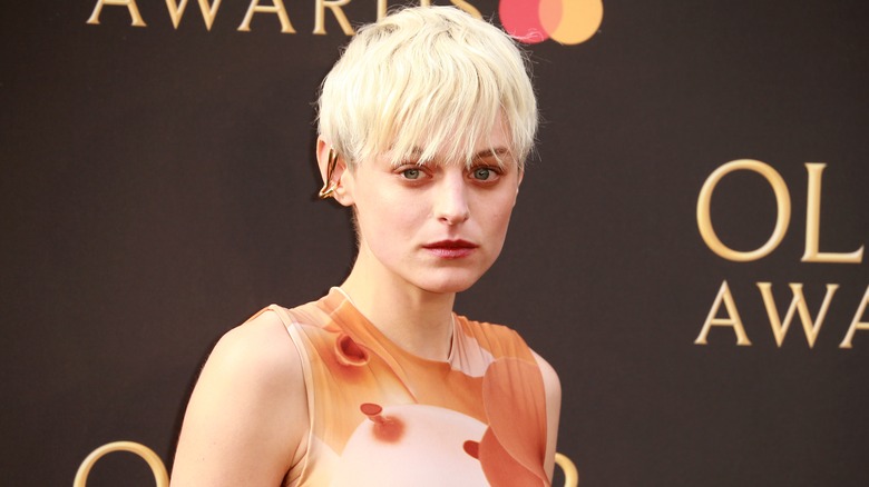 Emma Corrin posing at an awards show