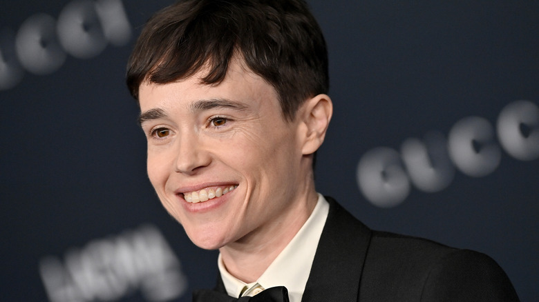 Elliot Page smiling on the red carpet