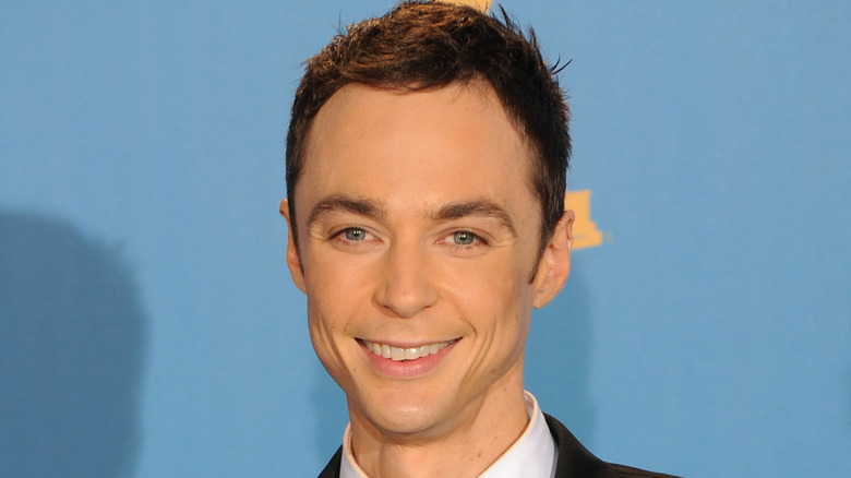 Jim Parsons posting in front of a blue background