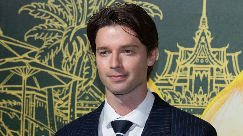 Patrick Schwarzenegger posing at the premiere of The White Lotus