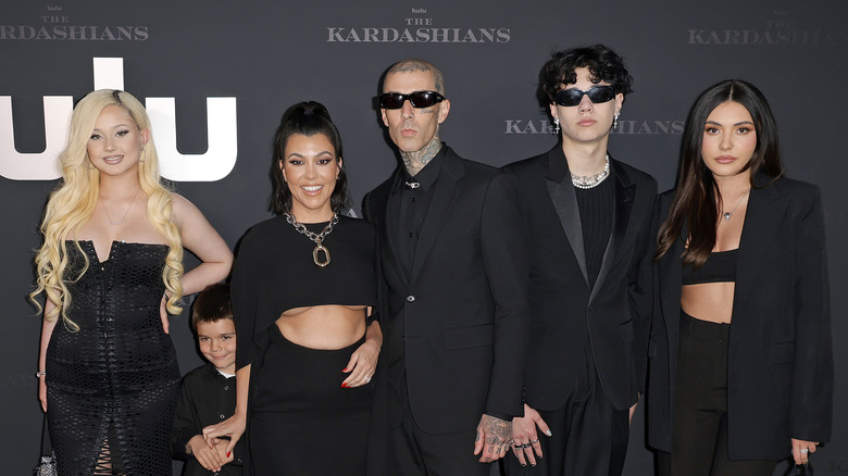 Travis Barker and Kourtney Kardashian posing with their kids