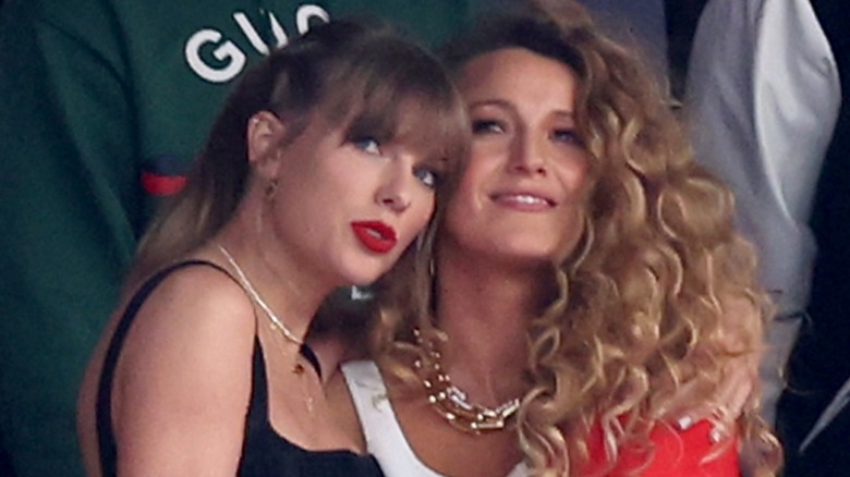 Taylor Swift hugs Blake Lively at a football game