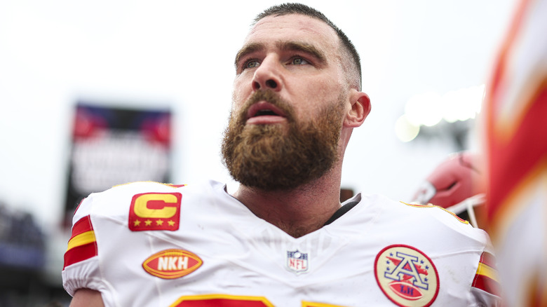 Travis Kelce looking up on football field