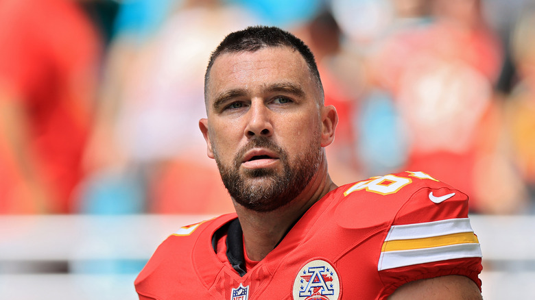 Travis Kelce looking pensive in his football gear