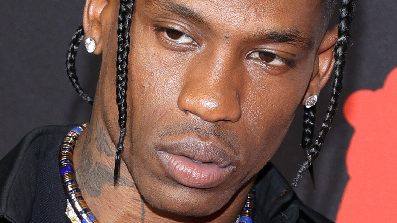 Travis Scott wearing diamond earrings