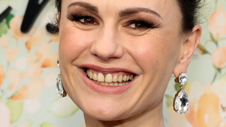 Anna Paquin smiling in diamond earrings