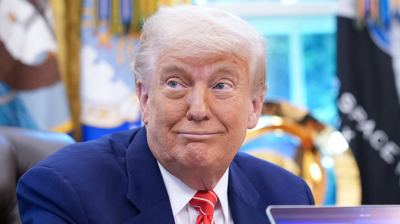 Donald Trump makes an animated expression in the Oval Office.