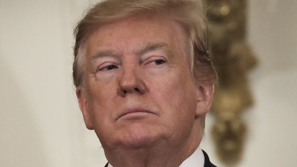 Donald Trump frowning at a presidential event