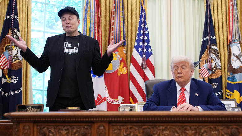 Elon Musk shrugging while Donald Trump sits at his desk in the White House