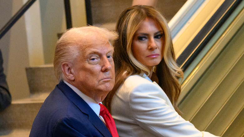 Donald Trump and Melania Trump walking up steps