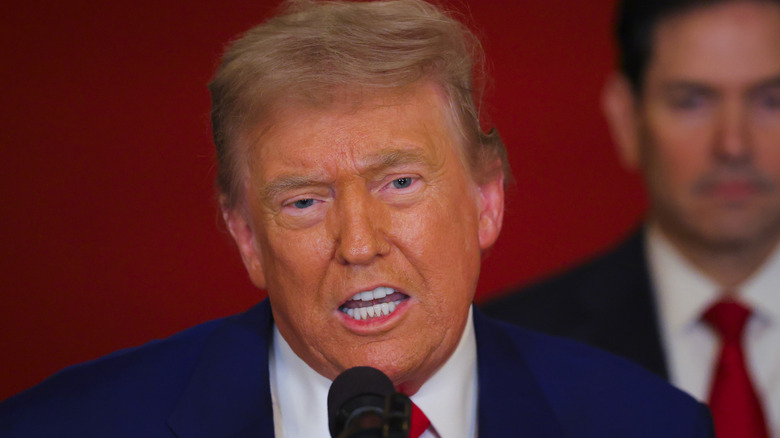 Donald Trump speaking into microphone
