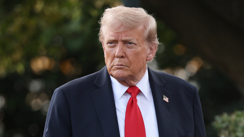 Donald Trump wearing a suit walking outside