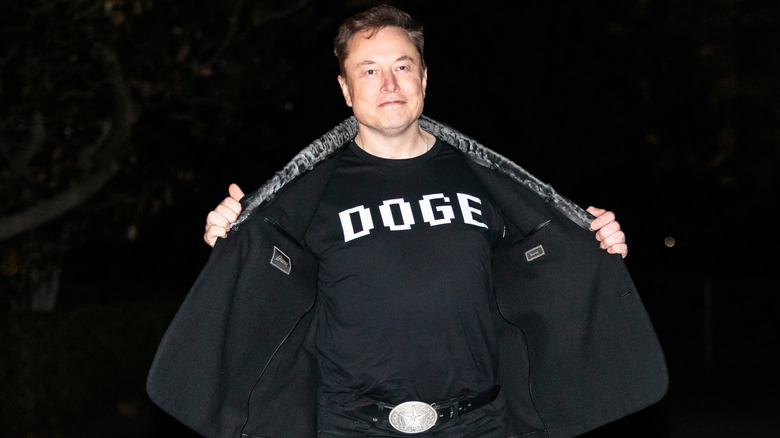 Elon Musk revealing his DOGE shirt before entering the White House