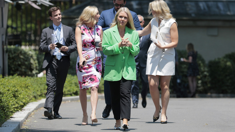 Karoline Leavitt walking in front of group of people