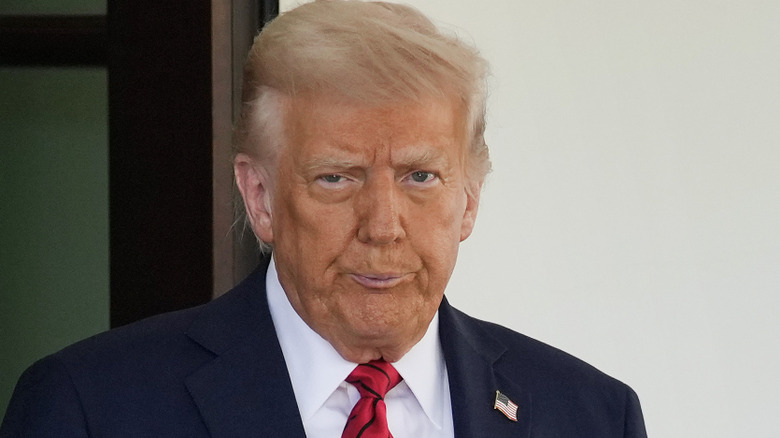 Donald Trump gives a thumbs up while wearing very orange makeup