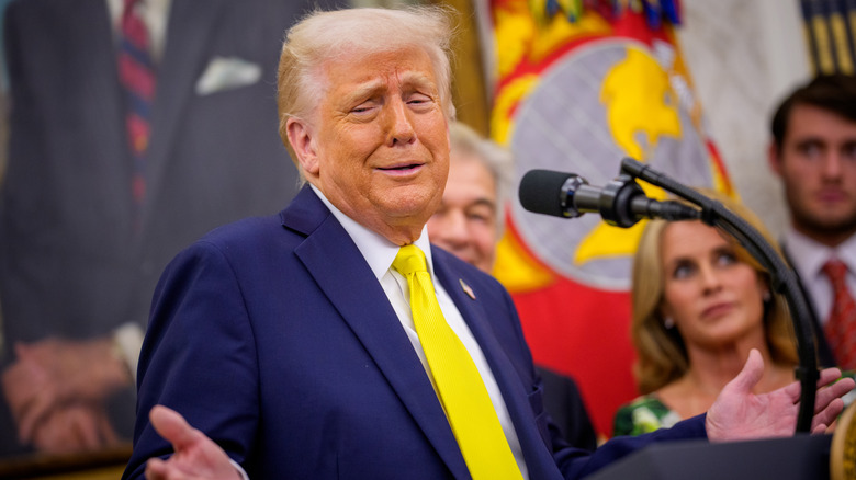 Donald Trump speaking to the press in a yellow tie