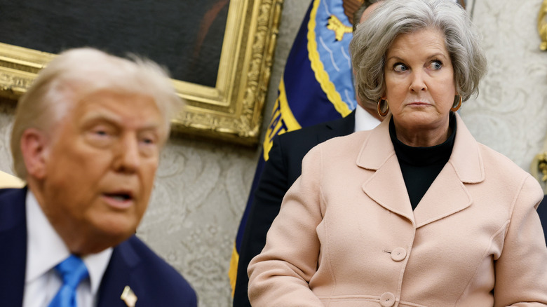 Susie Wiles standing behind Donald Trump