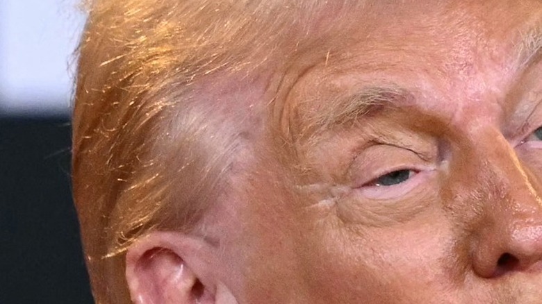 Donald Trump speaking into a microphone