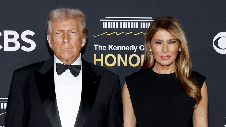 Donald and Melania Trump posing together at the Kennedy Center Honors in black tie outfits