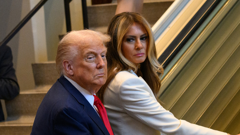 Melania looking at Donald Trump with disdain