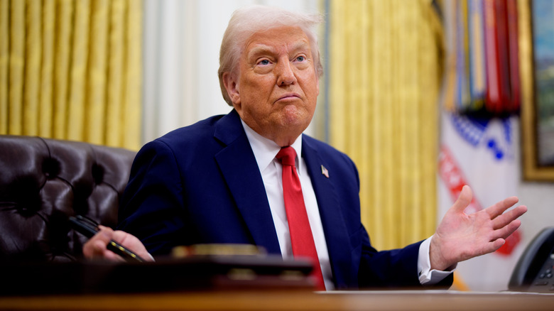 Donald Trump gives a shrugging gesture.
