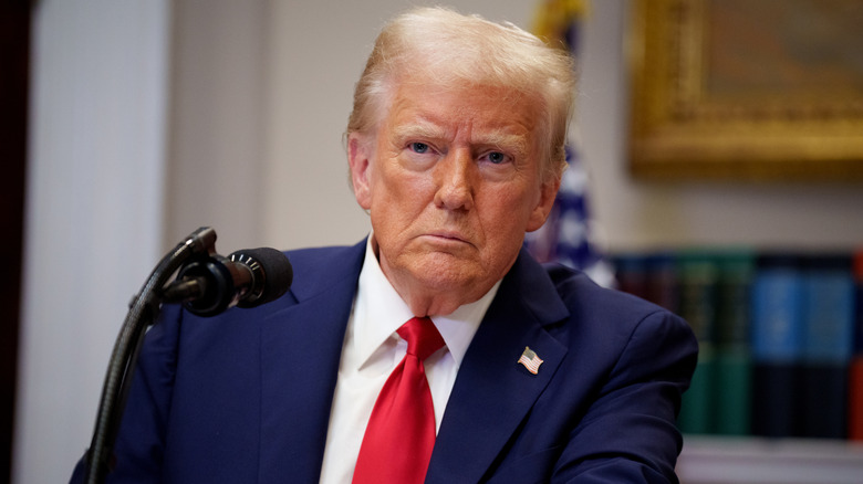 Donald Trump taking a question from a reporter during a news conference in the Roosevelt Room of the White House