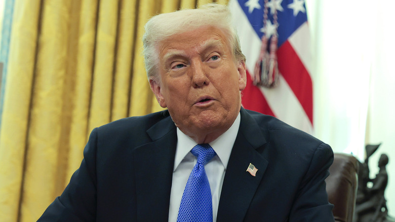 Donald Trump wearing a blue tie inside the Oval Office