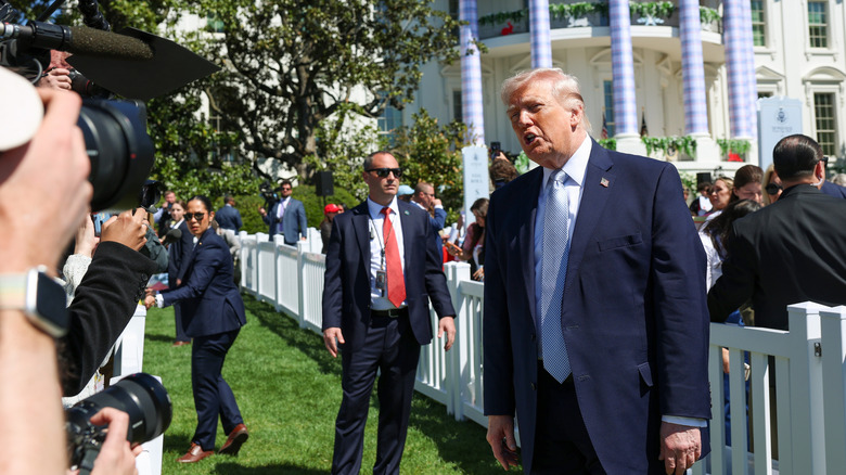 Donald Trump speaking animatedly to the press at the Easter Egg Roll