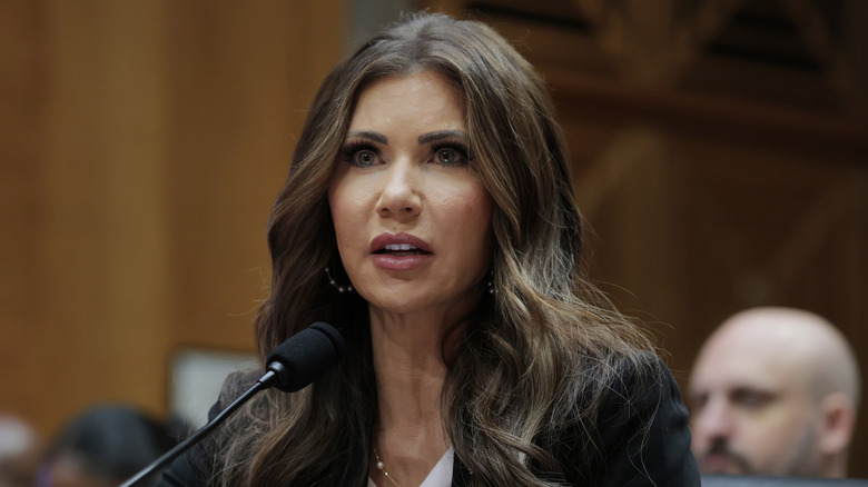 Kristi Noem speaking into microphone during a hearing with the Senate Committee on Homeland Security and Governmental Affairs on Capitol Hill on May 20, 2025