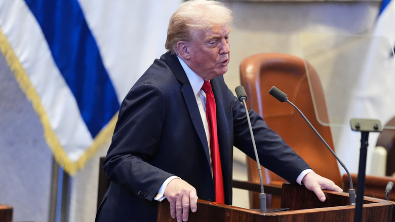 Donald Trump speaking at a podium
