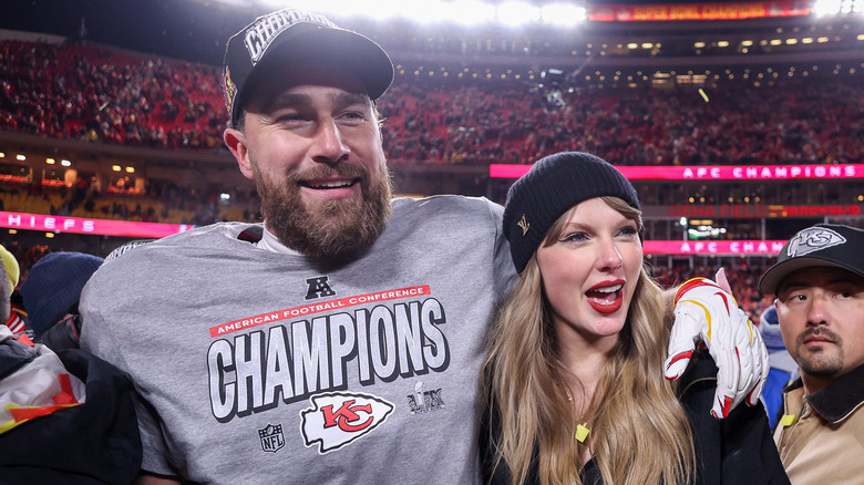 Travis Kelce and Taylor Swift celebrating on the field