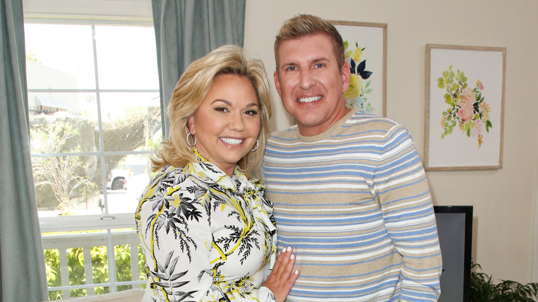 Julie Chrisley palm tree shirt, Todd Chrisley striped sweater