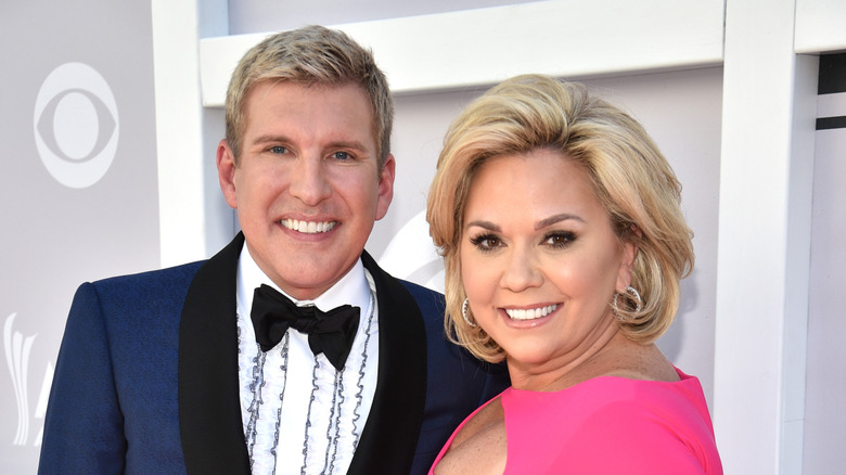 Todd and Julie Chrisley smiling in their finery at an event