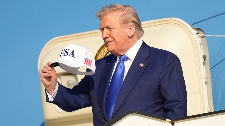 Donald Trump holding hat