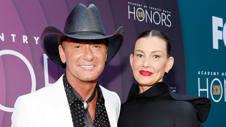 Faith Hill and Tim McGraw smiling and posing together
