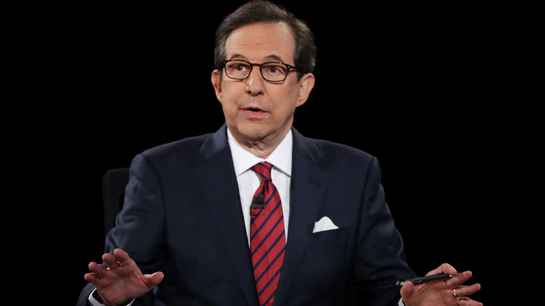 Chris Wallace holding pen