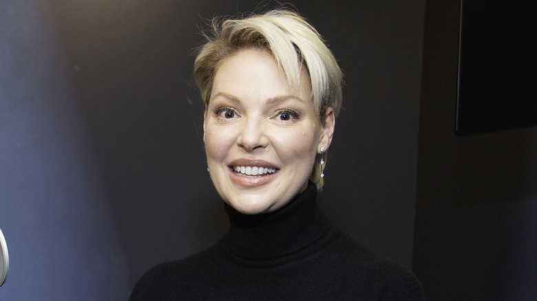 Katherine Heigl posing in front of a microphone