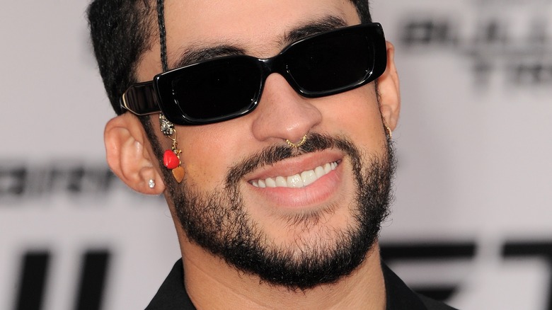 Bad Bunny smiling with black sunglasses