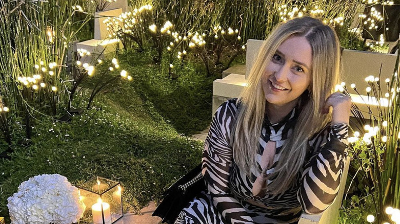 Morgan Absher posing with lighted plants
