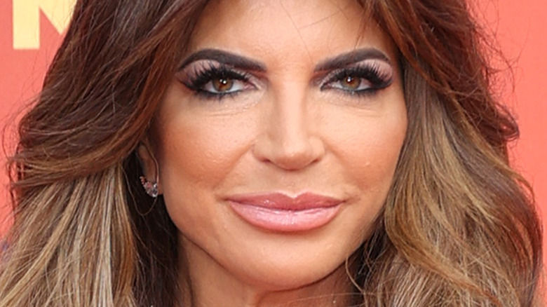 Teresa Giudice tan face large hair smiling